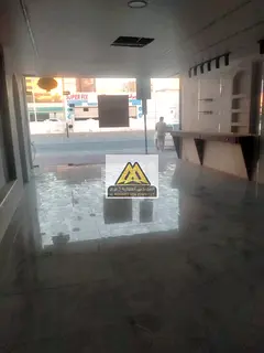 Commercial Shop with Mezzanine for Rent in Al Rashidiya 1 Ajman – Prime Location with Large Fronta