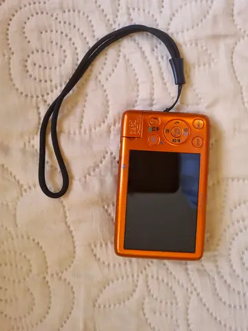 Compact orange Canon digital point-and-shoot camera - used, good condition