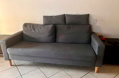 Grey 2-Seater Sofa with Wooden Legs - Good Condition