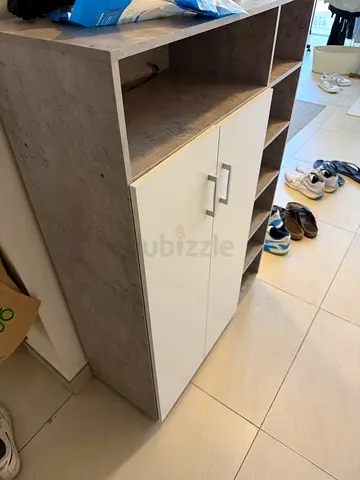 Shoe storage cabinet with cubby shelves and double doors