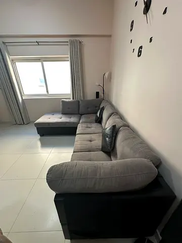 Grey L-shaped sectional sofa in good condition