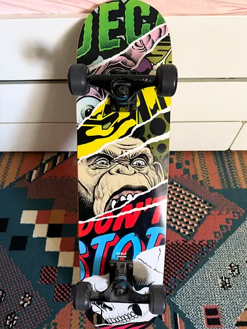 Used standard street skateboard with graphic deck and black trucks