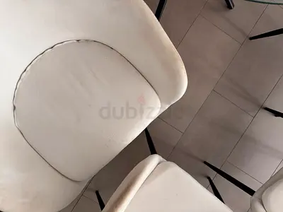 Set of 4 white upholstered dining chairs with black legs