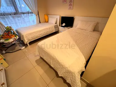 Two single beds with mattress and bedside table - good condition