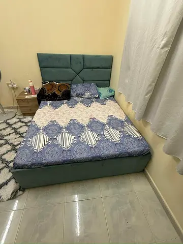 Queen upholstered bed with padded headboard - good condition