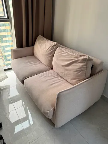 Light beige two-seater sofa - bed function