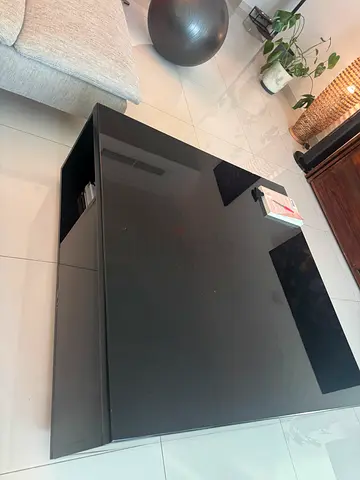 Black moderncoffee table with storage, solid wood with a glassy glossy finish, storage inside
