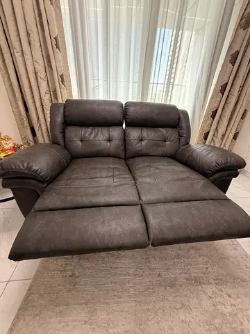 Comfortable two-seater reclining sofa in black leather