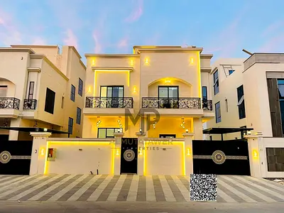 A luxurious two-story villa with a modern design, featuring six master bedrooms, an elegant majlis, and a spacious lounge.