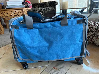 Lightweight Blue Rolling carrier bag for pets transport with wheels . Never used
