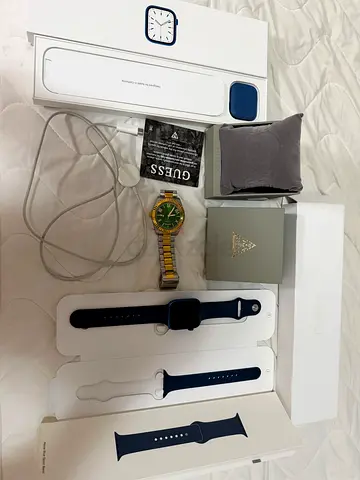 Apple Watch Series 7, 45mm, Abyss Blue” and “Guess Steel Analog Watch, 42mm.