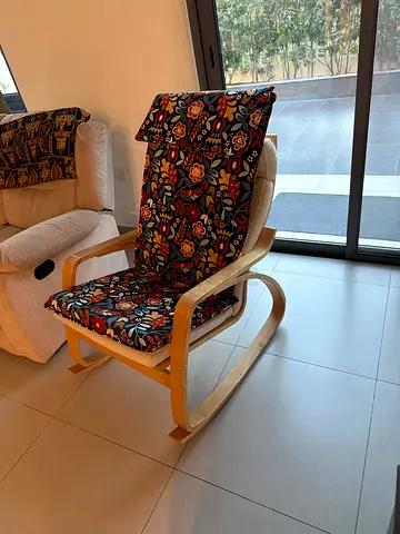 IKEA Poäng Armchair with Floral Cushion (Light Wood Frame). original price 670 aed .extra cushion