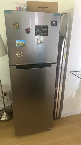 Slim single-door refrigerator in stainless steel finish — good condition