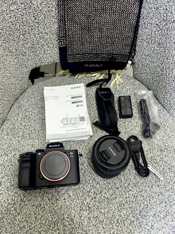Sony Alpha a7 III mirrorless camera body with 28-70mm kit lens and accessories