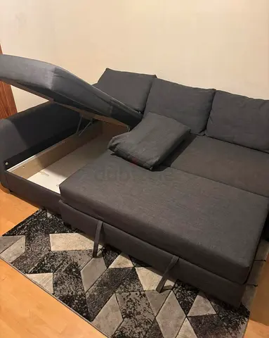 Grey L-shaped storage sofa bed — good condition