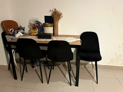 Minimalist dining table with four black chairs — good condition