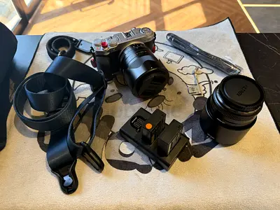 Fujifilm XM5 mirrorless camera with two lenses, strap and accessories