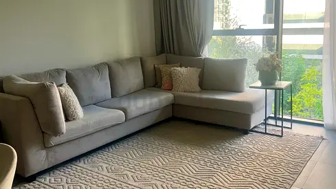 Light grey L-shaped sofa with chaise and cushions - good condition