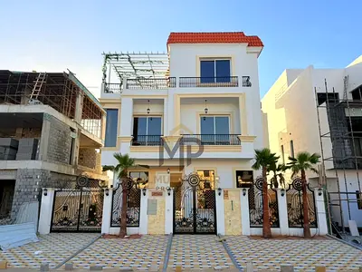 Two-story villa with a rooftop terrace and swimming pool at a special price, including electricity, water, and air conditioning, in one of Ajman's mos