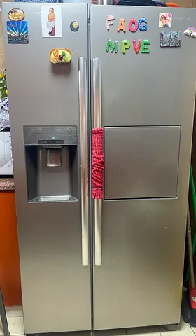 Side-by-side stainless steel refrigerator with water dispenser — good working condition