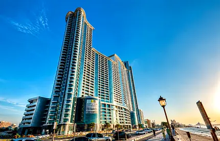 A beachfront apartment with an American-style kitchen, gym, swimming pool, parking, and laundry roo
