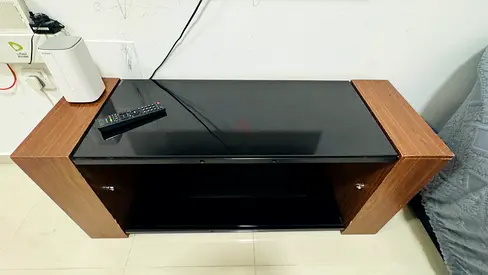 Compact wooden TV stand with black glass top - good condition