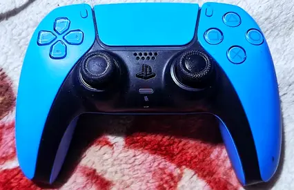 Used DualSense PS5 Controller - Blue Silicone Skin, Working and in very good condition.
