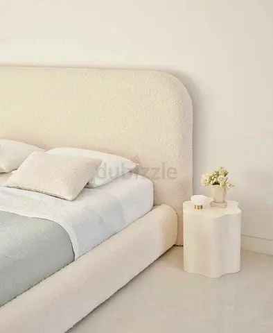Cream upholstered bed frame with rounded headboard (used)