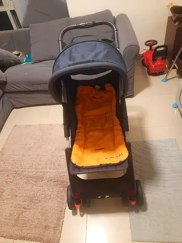 Lightweight pram stroller with orange liner - good condition