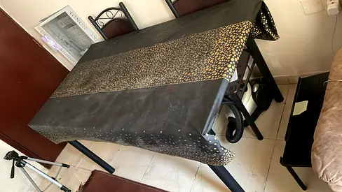 Dining table with 4 chairs — used, sturdy black set with patterned tablecloth