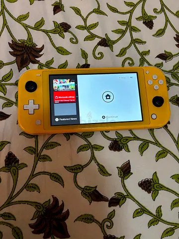 Yellow Nintendo Switch Lite in good working condition with FIFA 26