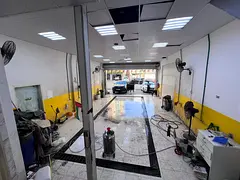 Al Rumaila 1 Car Wash, second row on Ajman Corniche, prime location next to car accessories shops. R