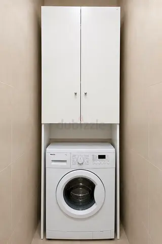 White IKEA NYSJÖN cabinet above the washing machine
