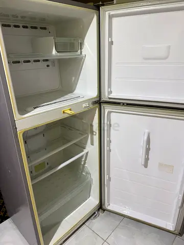 Used Double door refrigerator with freezer compartment - good condition