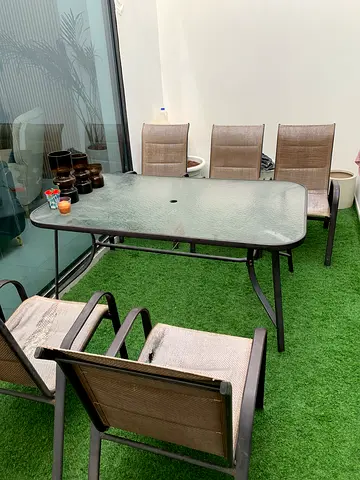 Outdoor glass-top dining table with 6 sling chairs (used)