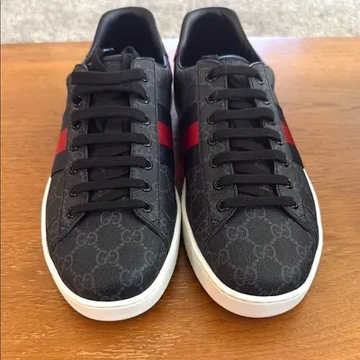 Gucci Ace GG Supreme Black Grey sneakers have a sleek silhouette.