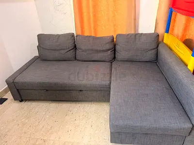 L-shaped sectional sofa with a chaise lounge, upholstered in a textured fabric.