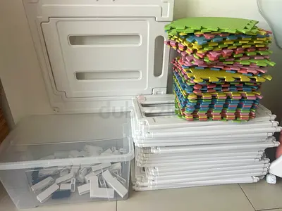 Used white baby playpen panels with colorful foam floor mats and connectors