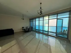 A spacious two-bedroom apartment with a balcony offering stunning sea views, built-in wardrobes, mas