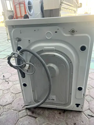 Used washing machine (back view) – functional, for parts or repair