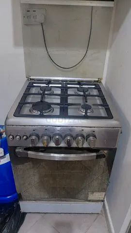 Used stainless steel gas range oven with 4 burners - working condition