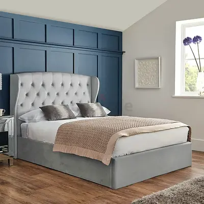 Grey upholstered king-size bed with tufted wingback headboard