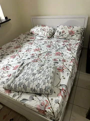 White platform bed frame with mattress and bedding - good condition