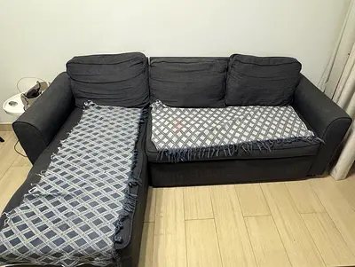 Dark grey L-shaped fabric sofa bed with storage - fair condition