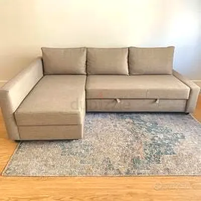 L-shaped beige fabric sofa with storage and pull-out bed (good condition)