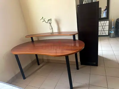 L-shaped wooden study/office desk with raised monitor shelf