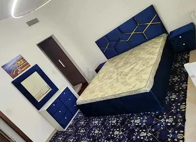 Blue upholstered king bed with mattress, matching bedside and dresser set