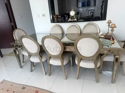 Glass-top dining table with 8 upholstered oval-back chairs - elegant set