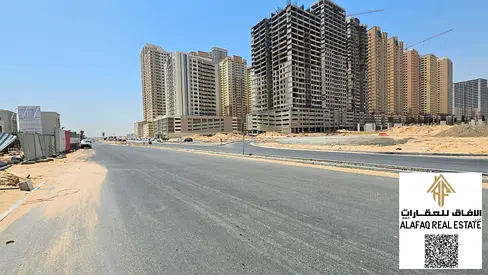 Commercial and residential land for sale in Al Aamra, prime location on a main road in front of a data center, investment opportunity priced at three