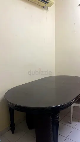 Dark wooden oval dining table - sturdy condition